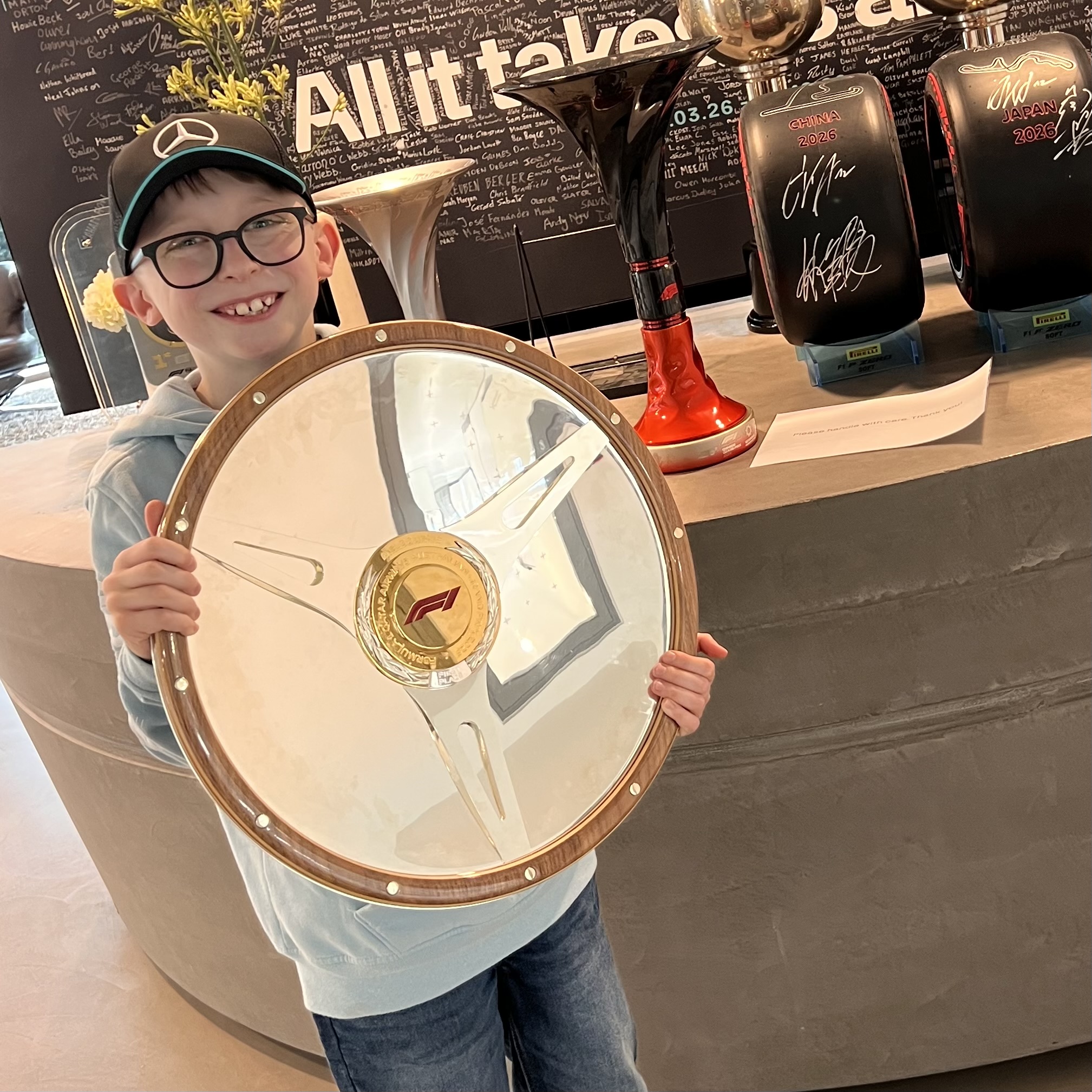 Ethan holding the same Australian Grand Prix trophy